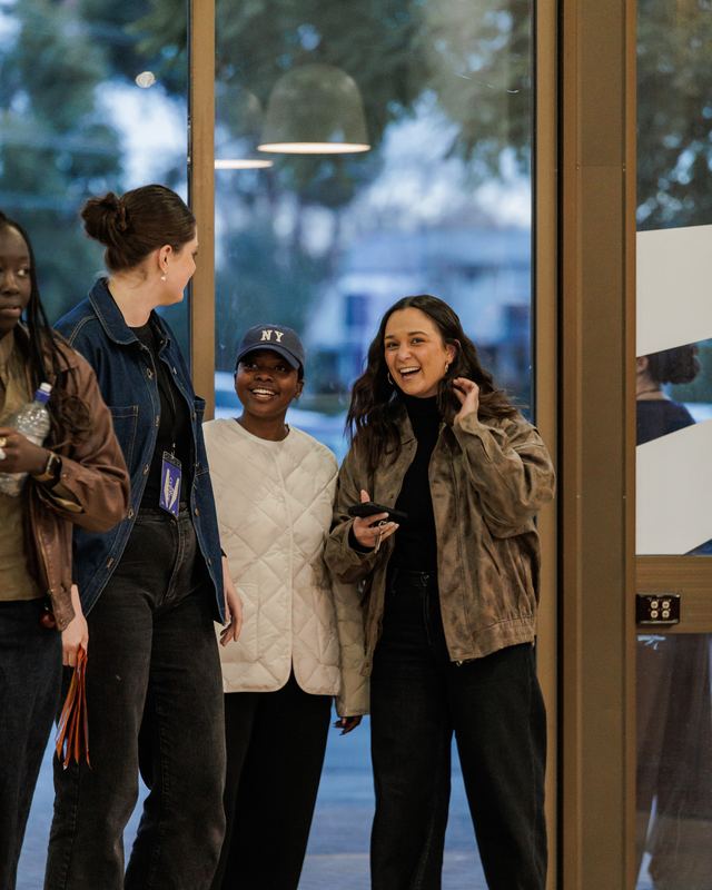 Three students cracking up at the door