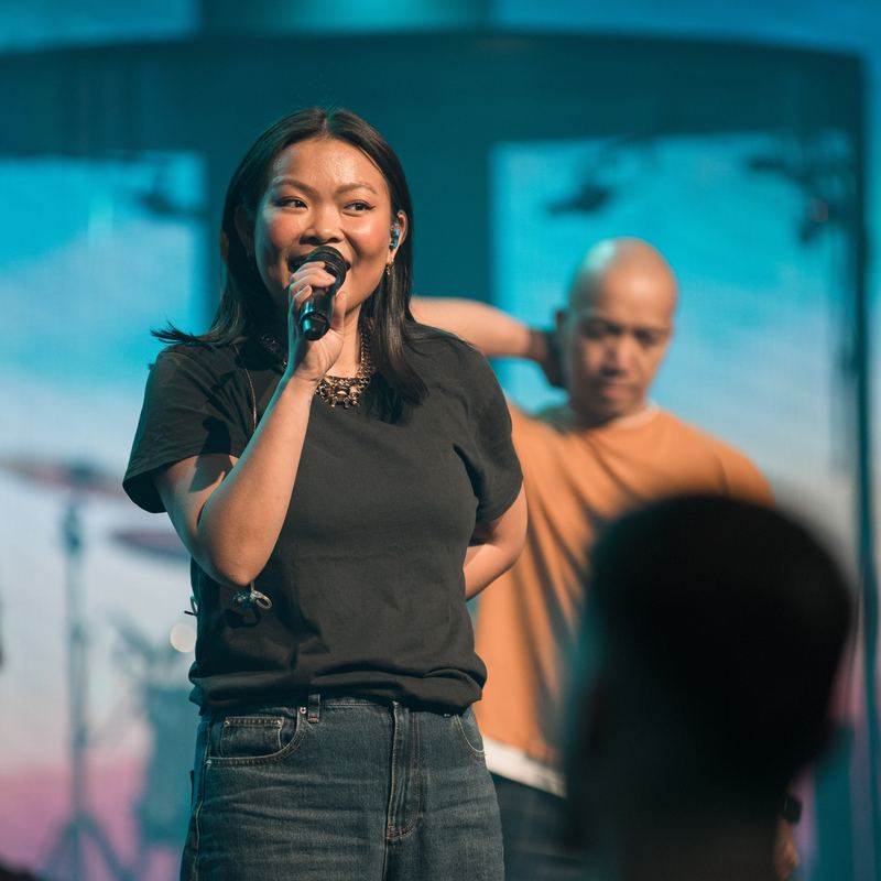Worship leader on stage with the band